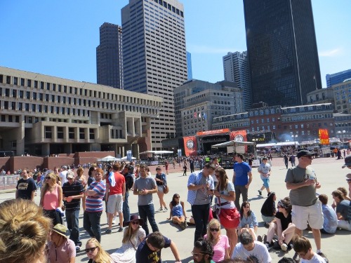 People begin to gather at the blue stage.