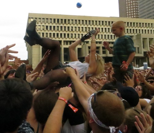 A young fan gets a close up of Anna Bulbrook's crowd surf during Airborne's set at Boston Calling