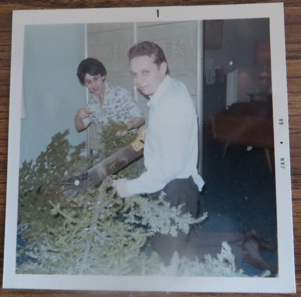 Two Jews trying to make a large Christmas tree disappear.